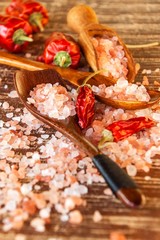 Himalayan pink salt. Kitchen salt and chili peppers. Spices on grill.