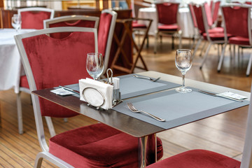 Tables, chairs and dining facilities in an empty restaurant.