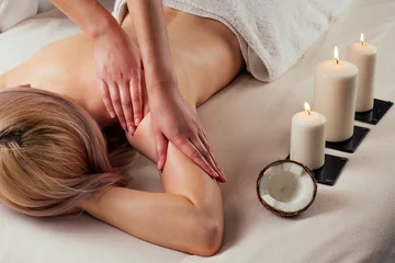 Printed roller blinds Ayurvedic relaxing.health beauty happy blonde woman in spa salon getting massage .Beautiful girl enjoying day spa resort, lying down on the table treatment procedure next to the candle fire