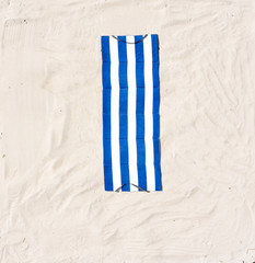 Aerial view of summer towel and umbrella on beach 