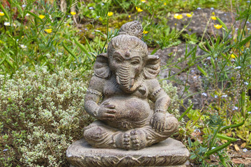 Fototapeta na wymiar Ganesha stone statue in a garden