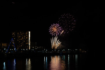 Friday night fireworks at Waikiki Beach, Honolulu cityscape at night, with negative space of blackness.