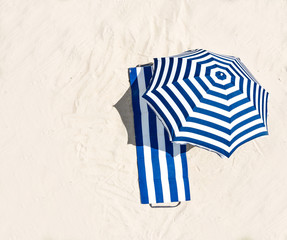 Aerial view of summer towel and umbrella on beach 
