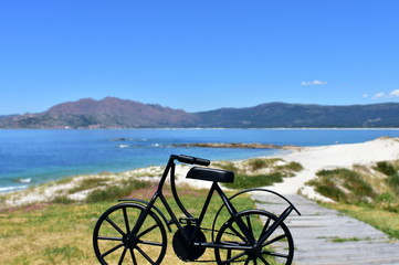 Fototapeta na wymiar Spain. Beach with black iron bicycle.