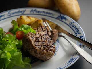 Grilled pork steak with vegetables salad.