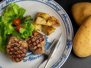 Grilled pork steak with vegetables salad.