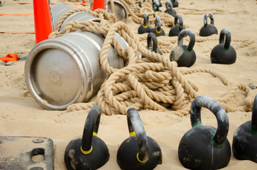 Barrel, tied with a rope and weights on the beach.