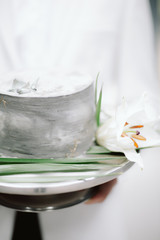  white wedding cake on a plate with flowers