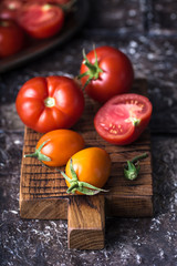 Still life of ripe tomatoes on wooden board