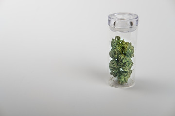 Side view, glass jar with cannabis, on white background