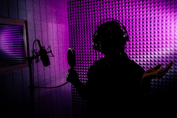 afro american woman with pigtails hairstyle headphones in a cap and a hood sunglasses recording hip...