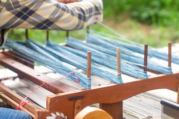 Thai style traditional hand-weaving loom being used to make cloth