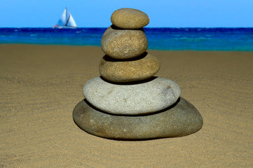 Fototapeta na wymiar Sea stones piled on top of each other against the sea