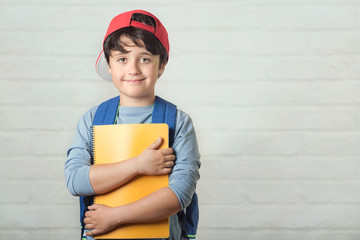 happy child with backpack and with notebook,back to school
