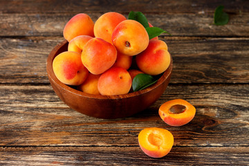 apricots in a bowl on wooden table