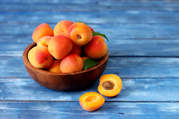 apricots in a bowl on wooden table
