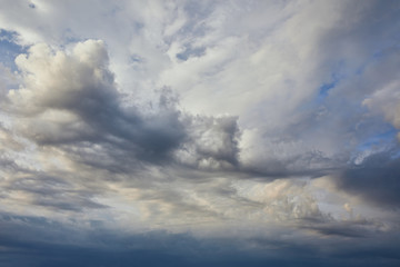 Naklejka na ściany i meble view of dark and white clouds on grey sky background
