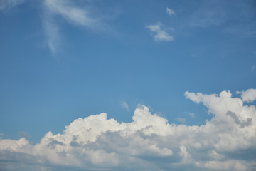 Naklejka na ściany i meble White clouds on bright blue sky with copy space