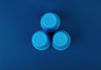 Three plastic blue glasses on a background
