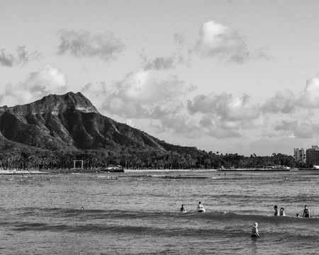 Diamond Head Crater taken from Magic Island, color and Black and white, surfers in wait puff-clouds kissing the crater
