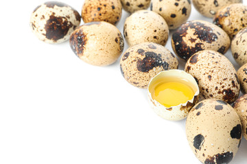 Fototapeta premium Quail eggs and half broken egg with yolk isolated on white background, closeup