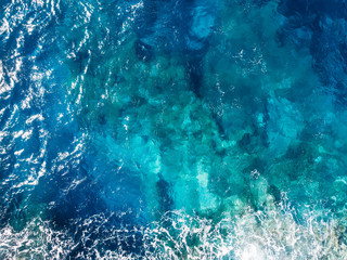 Raging blue water of open Mediterranean Sea with turquoise bottom. top view - Powered by Adobe