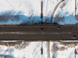 Aerial view of a road with traffic in winter landscape