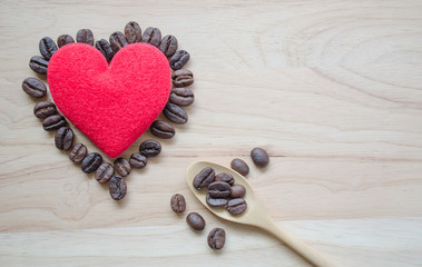 .Coffee beans with a wooden spoon, scoop, coffee beans and red hearts on a wooden background For text input