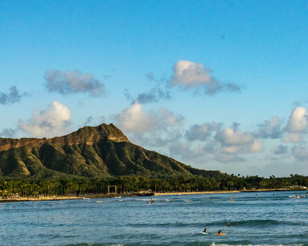 Diamond Head Crater taken from Magic Island, color and Black and white, surfers in wait puff-clouds kissing the crater