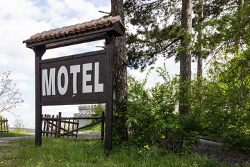 Motel sign in Bulgarian rural town Malco Tarnovo, green landscape, Bulgaria