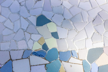 Ceramic tile vintage pattern. White background broken glass mosaic, decoration in Park Guell,...