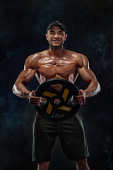 Fototapeta na wymiar Muscular fitness sports man, atlete with barbell in fitness gym.