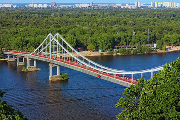 Aerial landscape view of River Dnipro with Pedestrian bridge. It connects the central part of Kyiv with the park area and the beaches of Trukhanov Island. Built in 1956-1957