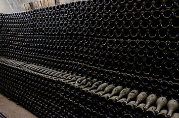 Wine bottles in the cellar. Wine cellar at the factory.