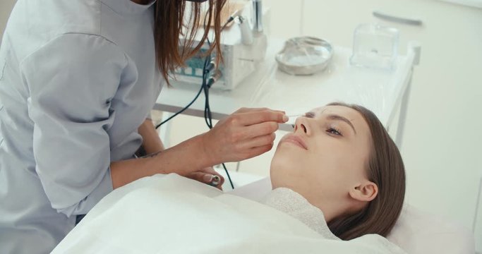 female client lying on white couch