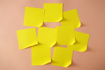 Fototapeta premium Yellow sticky notes with curled corner on pink background, copy space for design