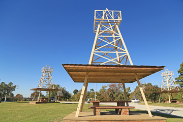 Picnic Tables alongside Interstate Highway in Texas shaded beneath models of Oil Drilling Rigs.