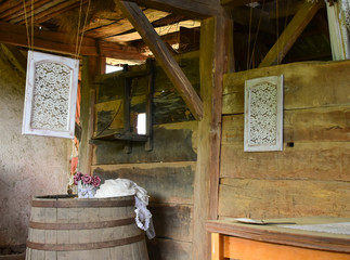 Room in old abandoned wooden cottage in the farm. With interesting  decoration, with dry flowers,  barrel and windows with lace.
