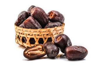 dates in basket isolated on white