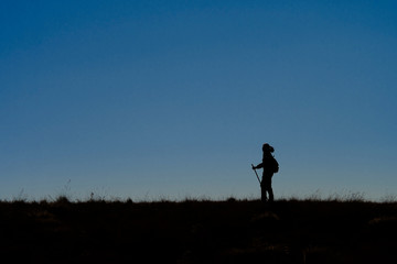 Naklejka na ściany i meble silhouette of man running on country road