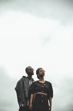 man and woman standing under clear skies