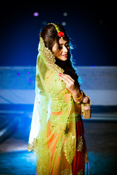 smiling woman wearing orange and brown sari dress