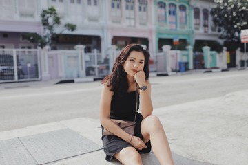 woman sitting on pavement