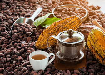 cup of coffee with beans and grinder