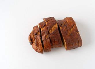 Pumpkin raisin bread slices on a white background