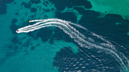 Aerial drone photo of extreme powerboat donut water-sports cruising in high speed in tropical...