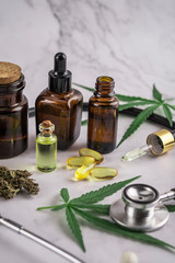 Assorted cannabis products, pills and cbd oil over medical prescription sheet - medical marijuana concept