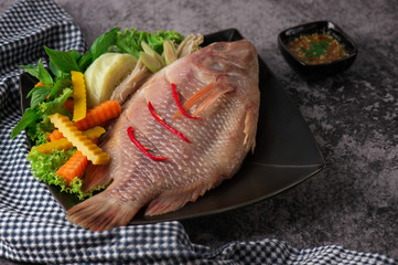 fresh fish with vegetables on a plate