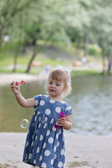 Adorable little girl blowing bubble