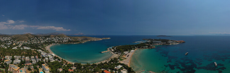 Naklejka na ściany i meble Aerial drone bird's eye panoramic photo of famous celebrity sandy beach of Astir or Asteras in south Athens riviera with turquoise clear waters, Vouliagmeni, Greece